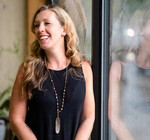 Jacqueline Fisch leaning near a window